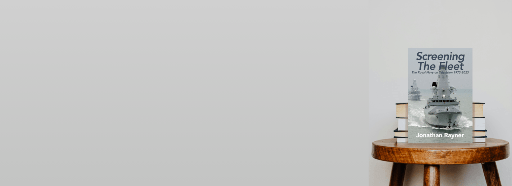 A book title 'Screening the Fleet' on a small wooden table against a grey background